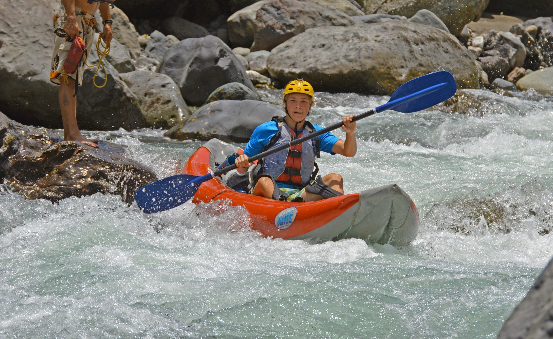 A man riding a kayak on top of a river